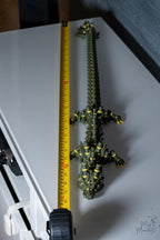 Bamboo dragon figure next to measuring tape for scale