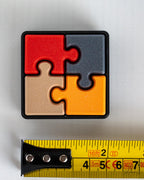 puzzle clicker next to measuring tape for scale