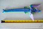 Winged dragon figure next to measuring tape for scale