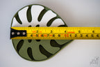 Monstera leaf soap dish next to measuring tape for scale