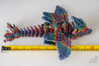 Rainbow Butterfly Dragon articulated next to measuring tape for a scale