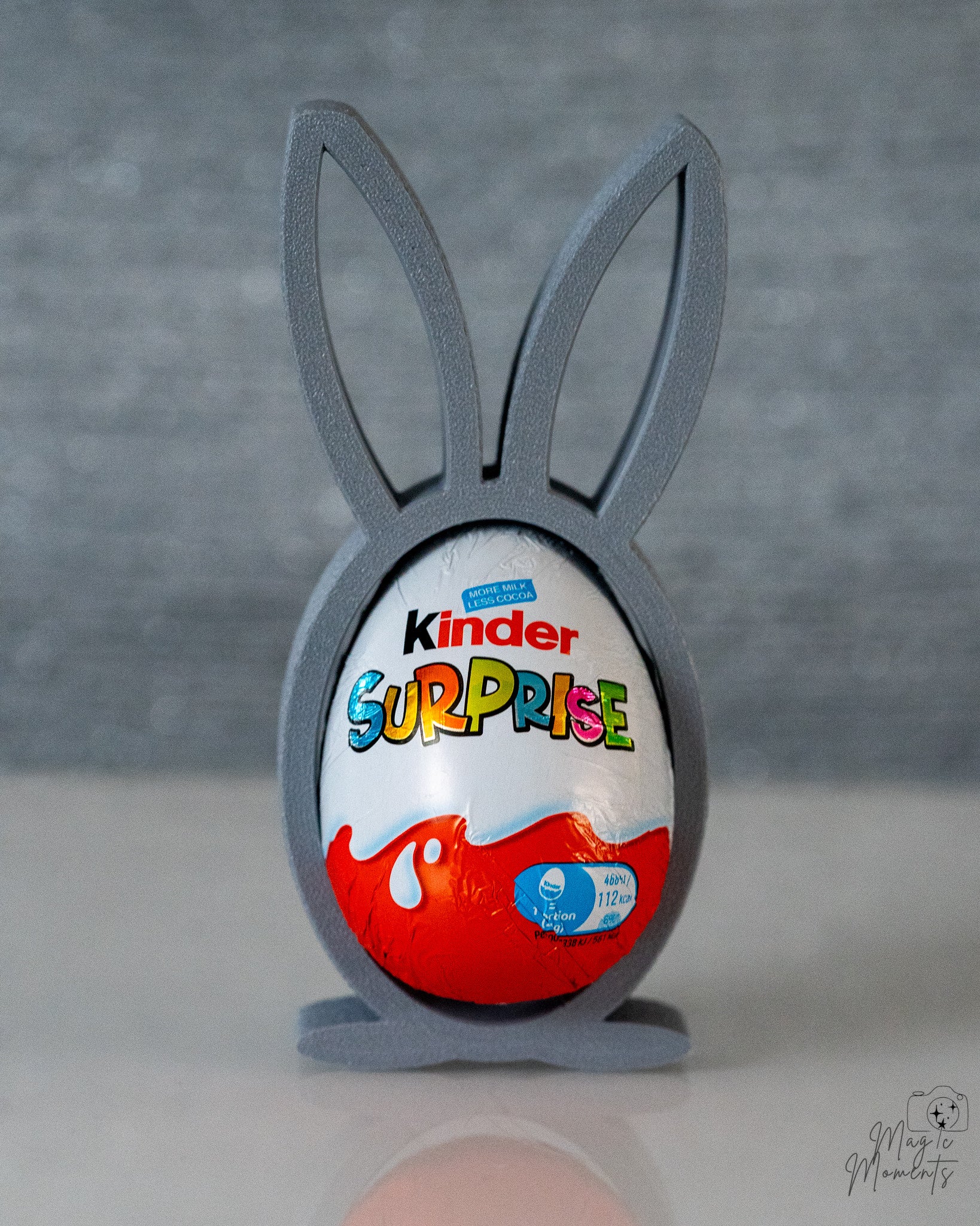 Grey bunny stand holding chocolate egg display