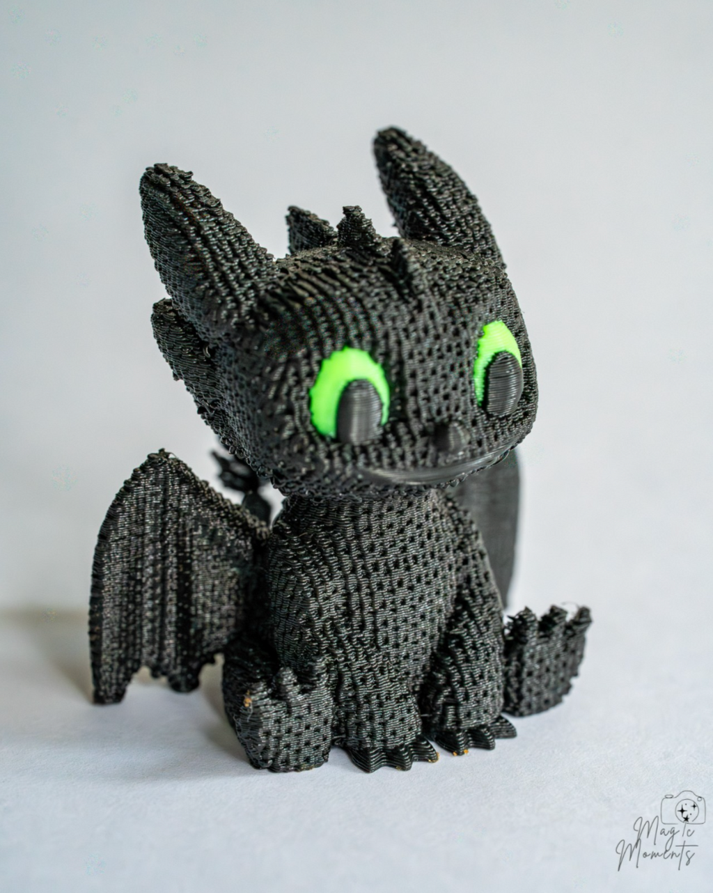 Night Fury inspired dragon figure with green eyes