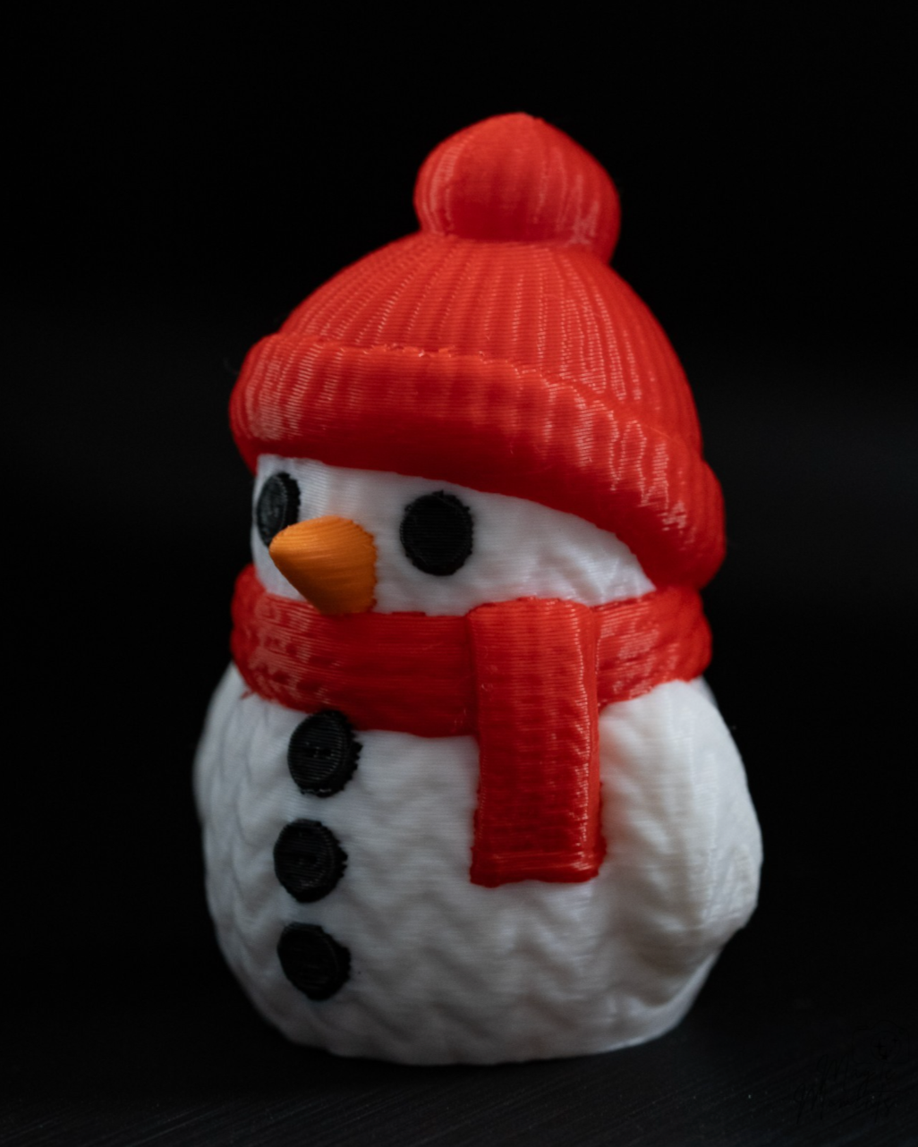 Mini knitted snowman figurine with red hat and scarf