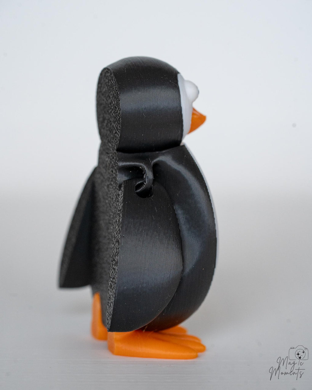 Side view of penguin figure with detailed wing design