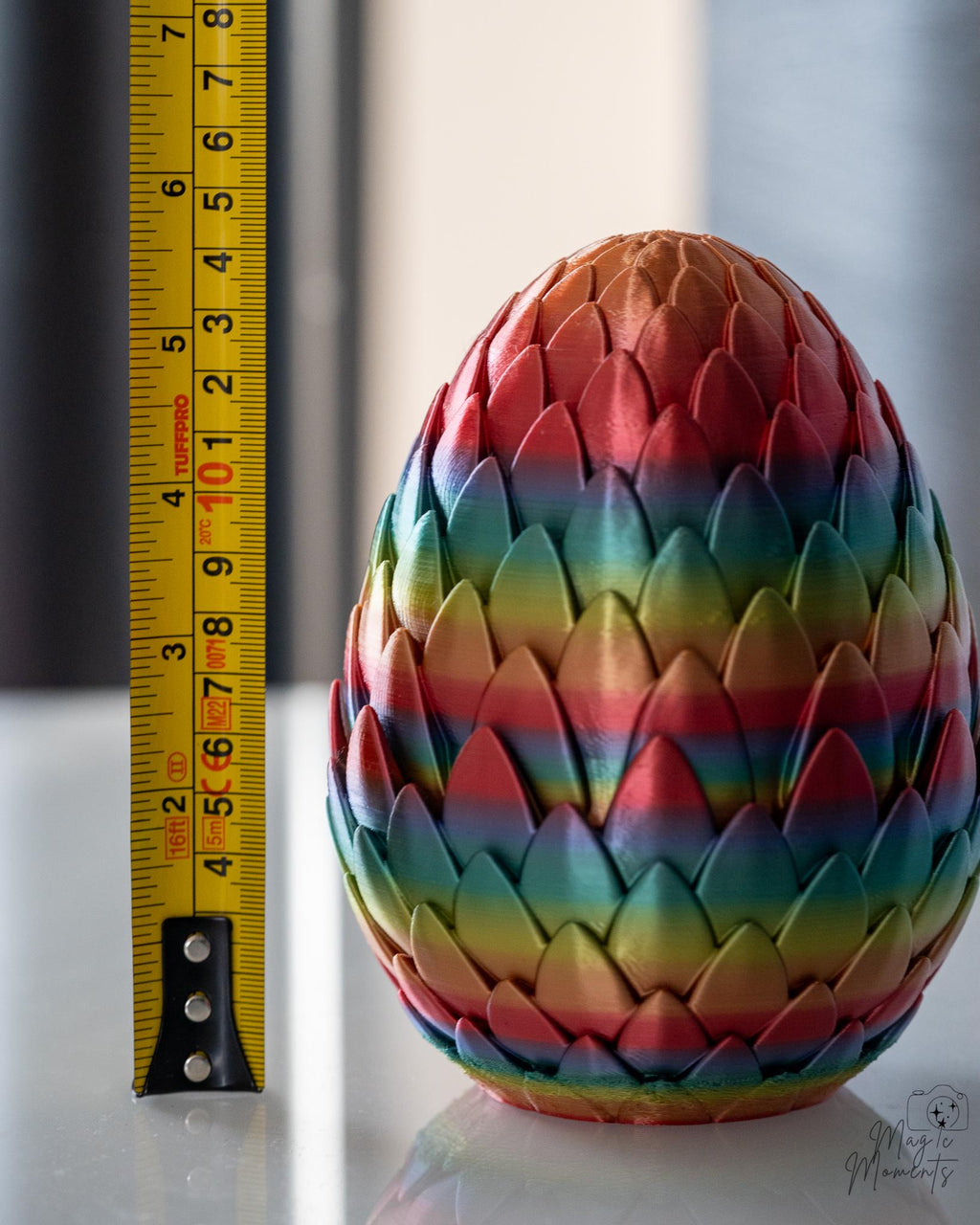 dragon egg next to measuring tape for scale