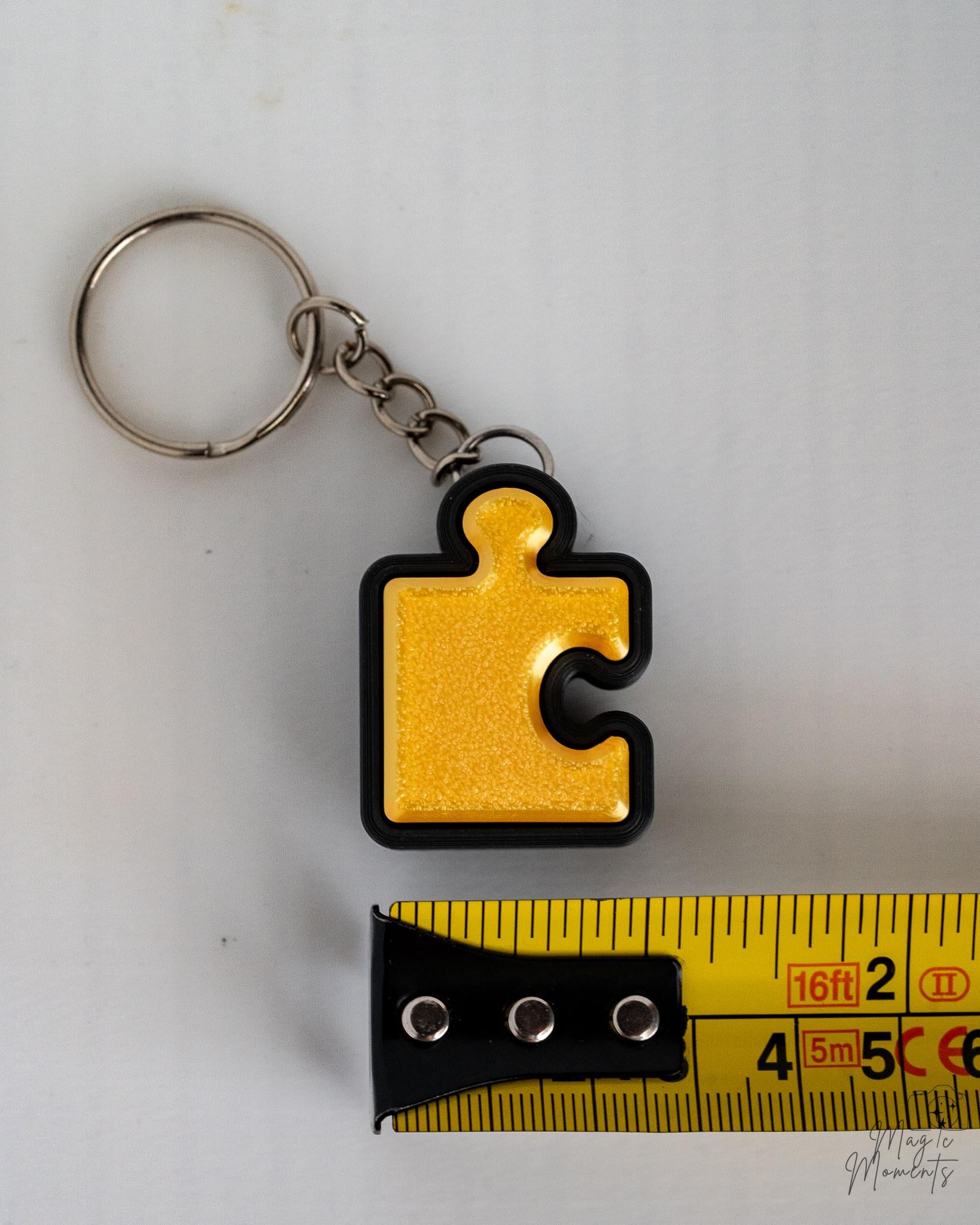 yellow puzzle piece clicker keychain