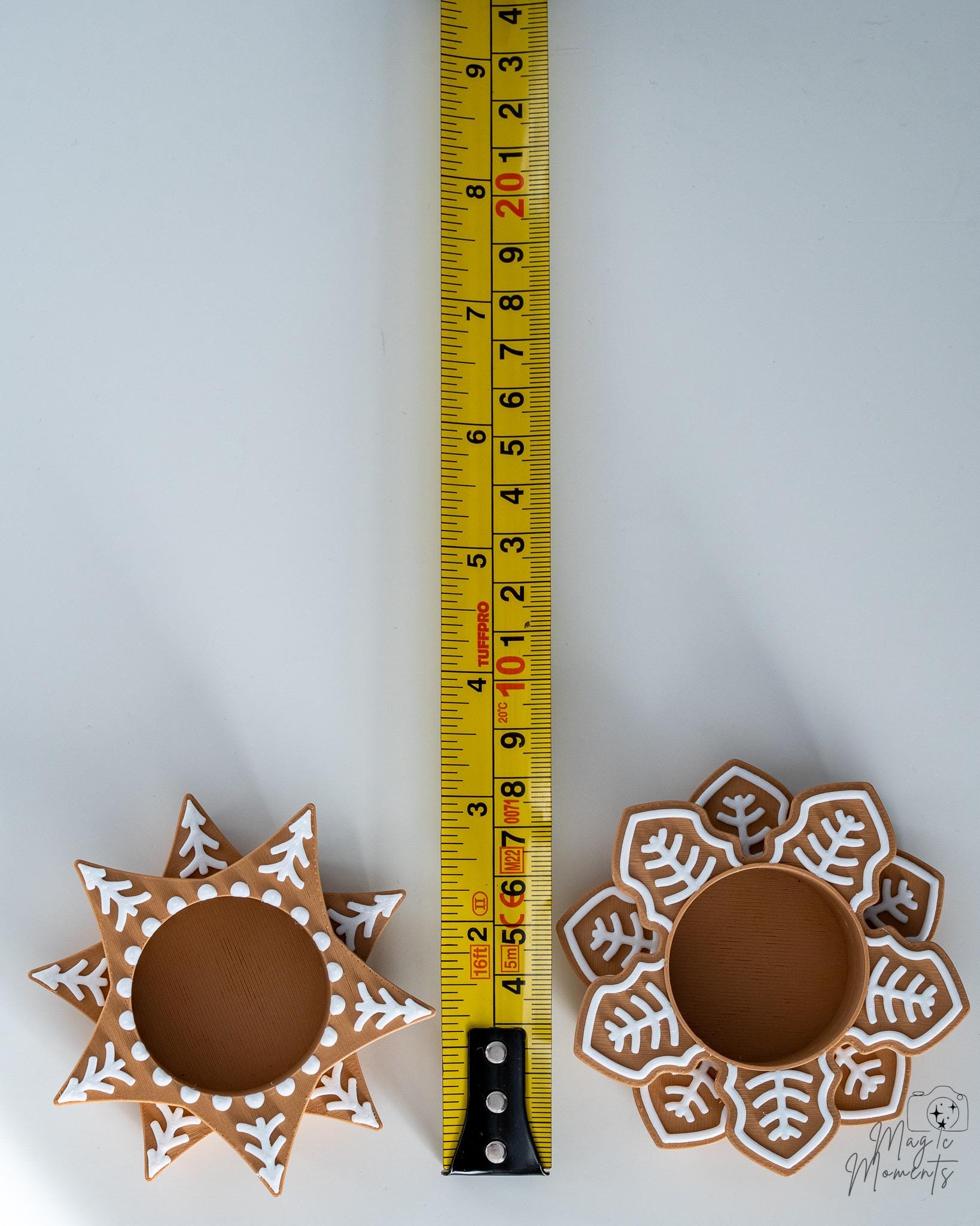 Snowflake tealight holders next to measuring tape for scale