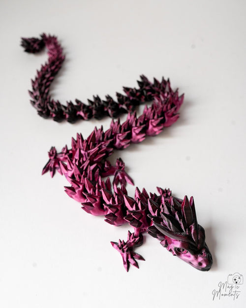 Pink and black dragon sculpture on a white background