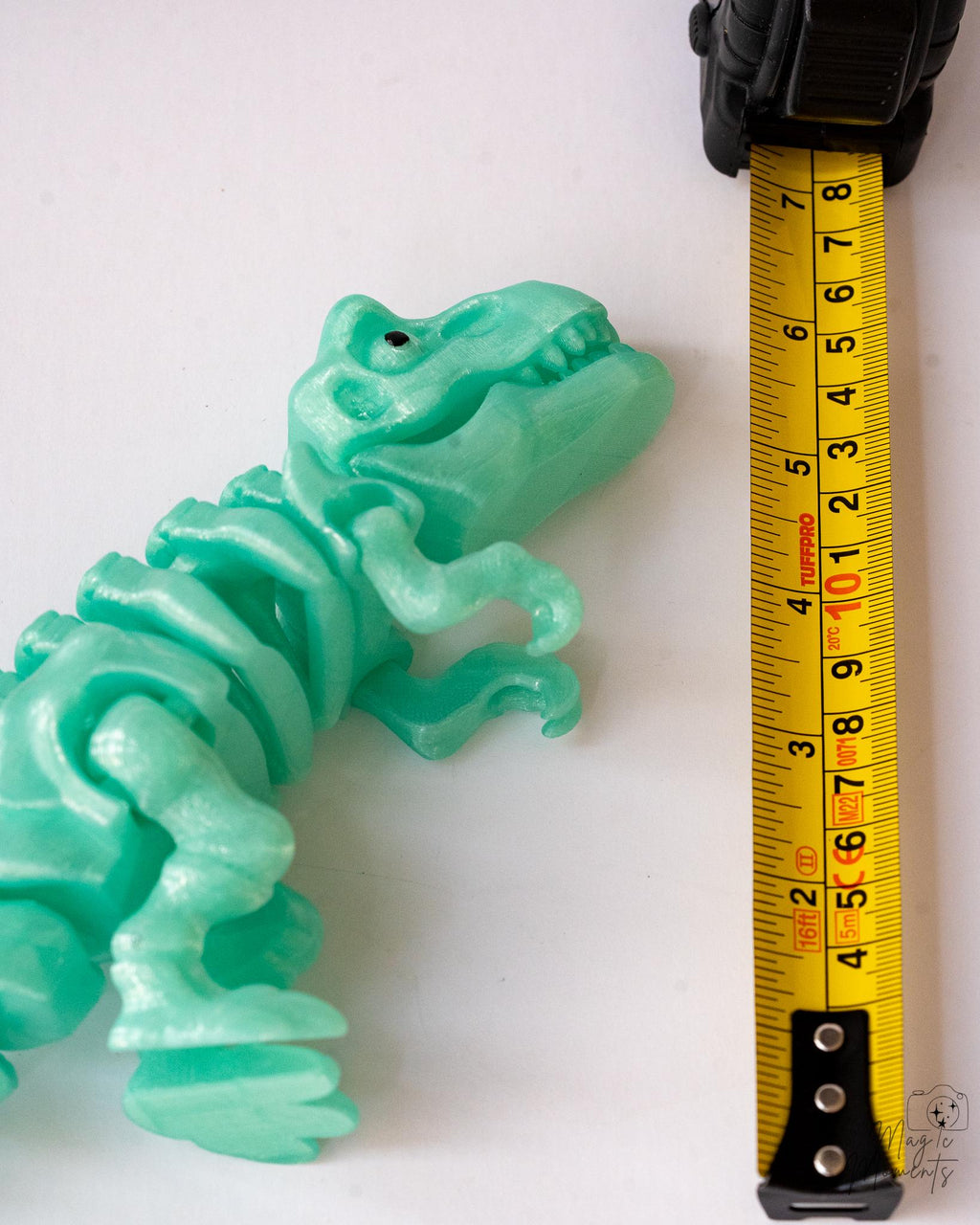 trex dinosaur next to measuring tape for scale