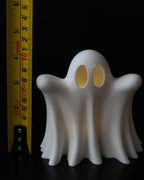 Halloween ghost decor next to measuring tape for scale