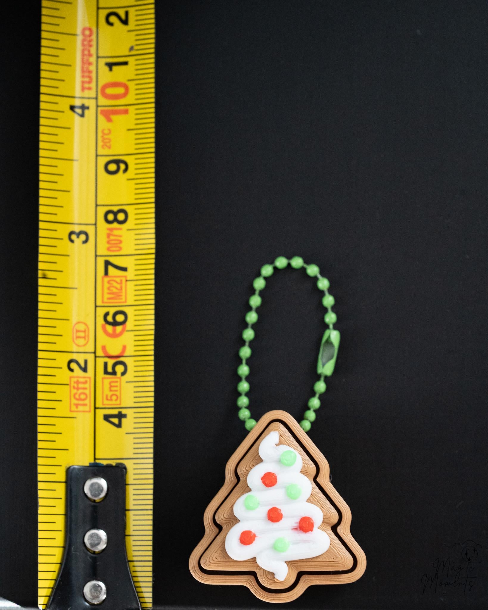 gingerbread christmas tree clicker next to measuring tape for scale