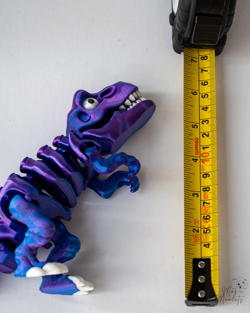 articulated skeleton t rex dinosaur next to measuring tape for scale