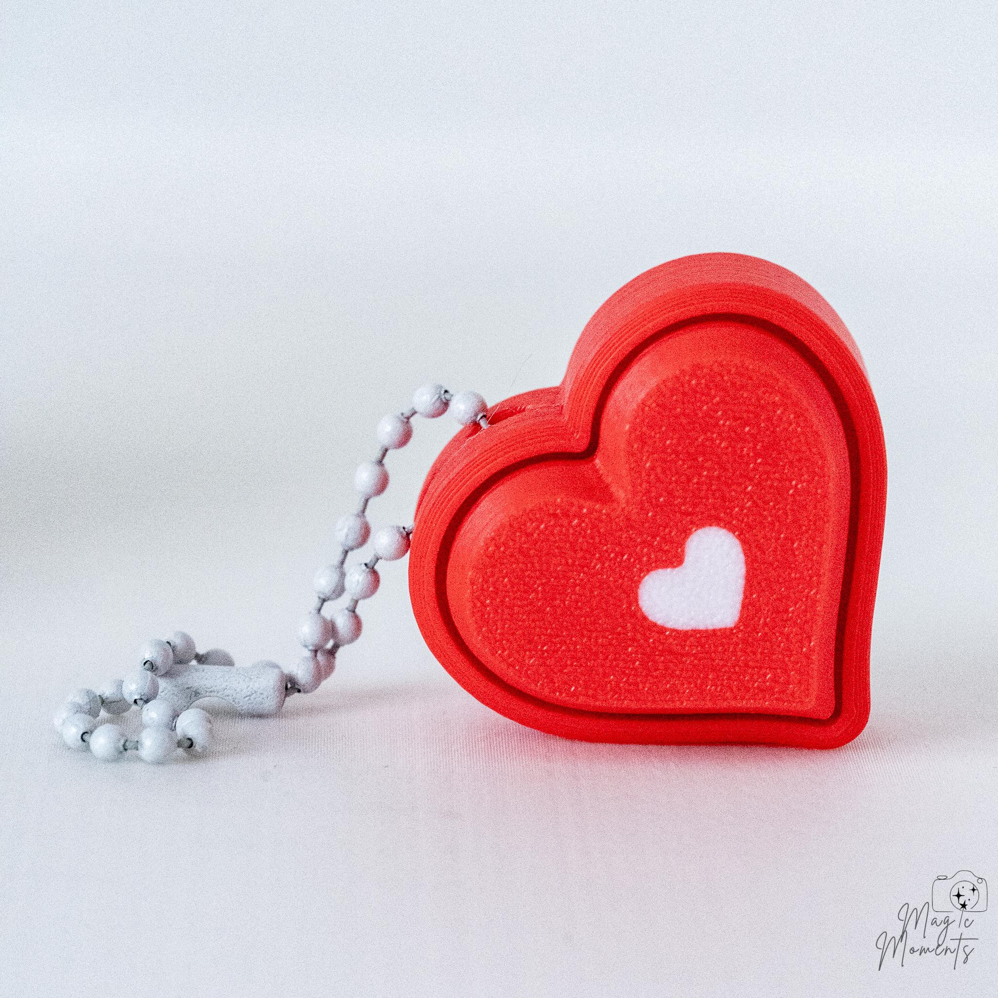 Heart clicker with white hanging loop and layered heart design