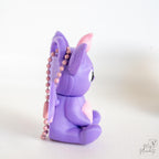 Side view of purple bat keychain figure with hanging loop