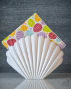 white shell napkin holder with napkins