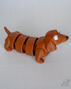 Brown articulated dog figure with segmented body