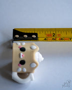 coffee cup clicker next to measuring tape for scale