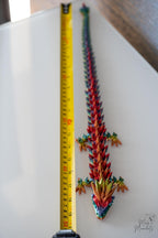 articulated dragon next to measuring tape for scale