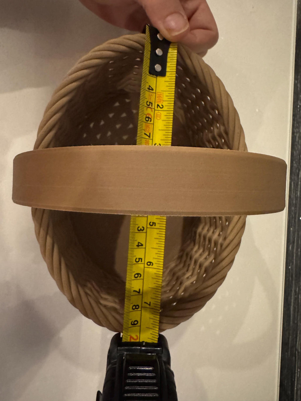brown woven basket depth next to measuring tape for scale