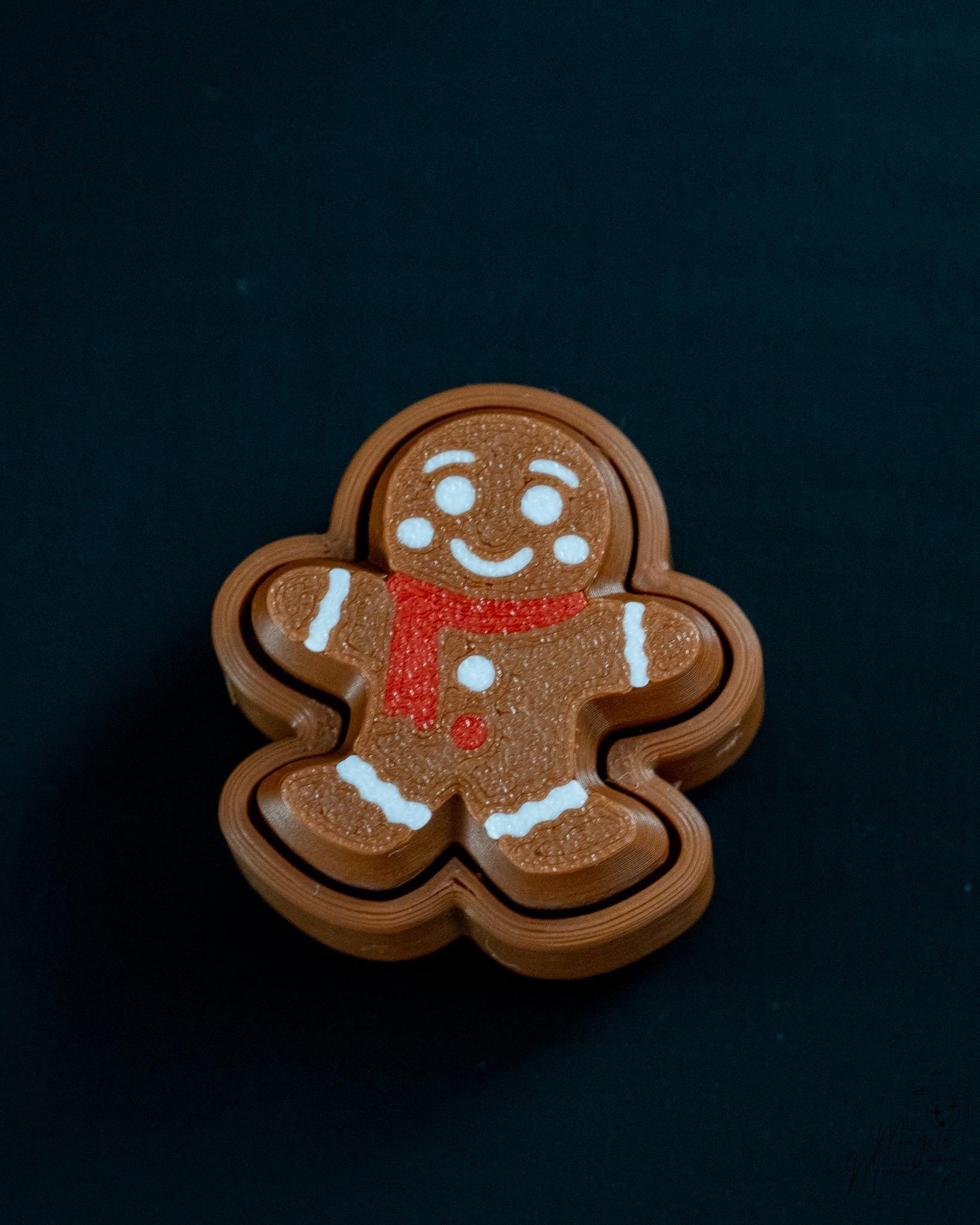 Small gingerbread clicker decoration with festive cookie appearance