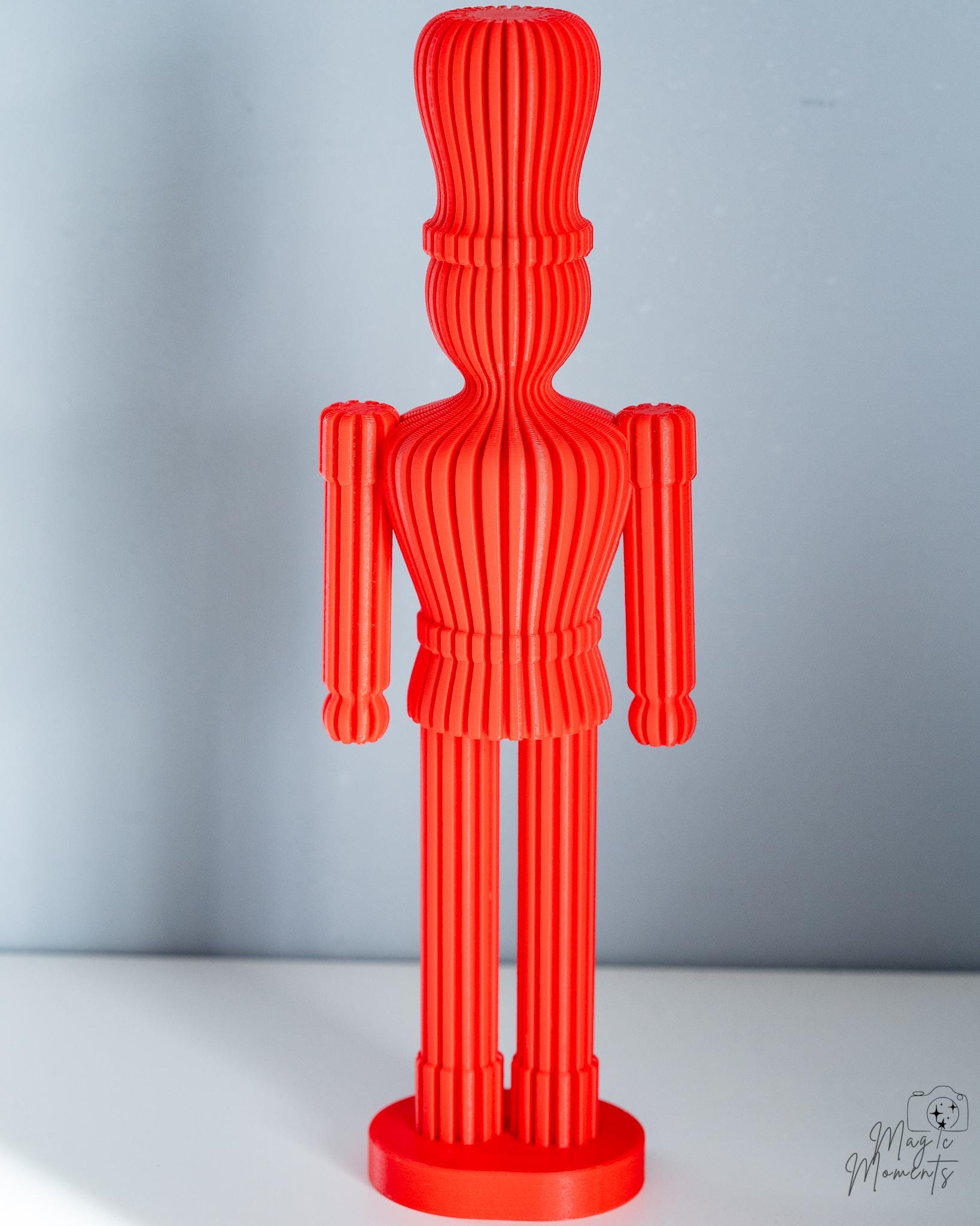 Red ribbed nutcracker decoration with layered spiral texture