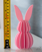 Pink bunny-shaped object next to a ruler for scale