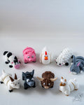 Collection of colorful animal figurines on a white background