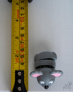 Cute koala figure next to measuring tape for scale