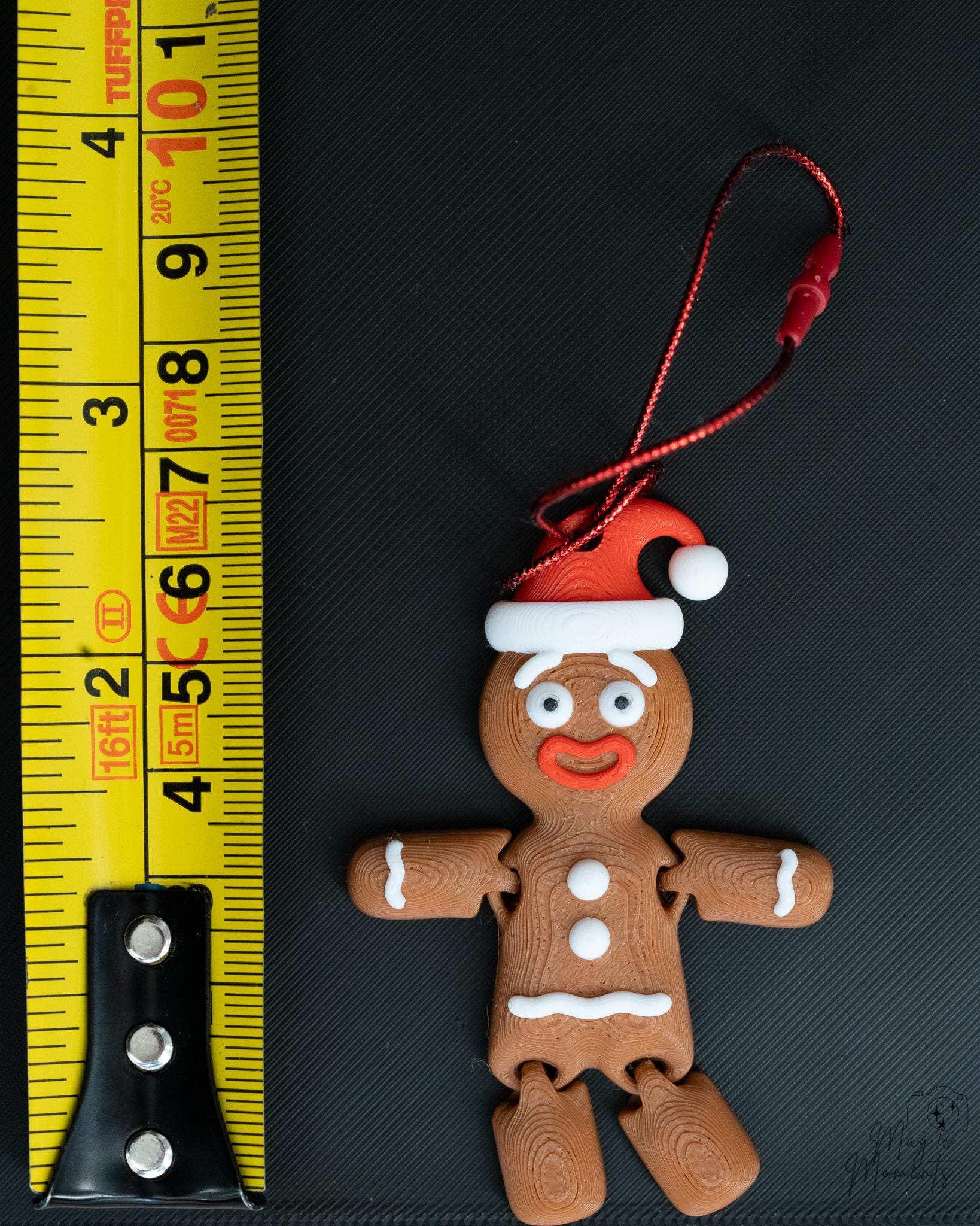 Gingerbread ornament next to measuring tape for scale