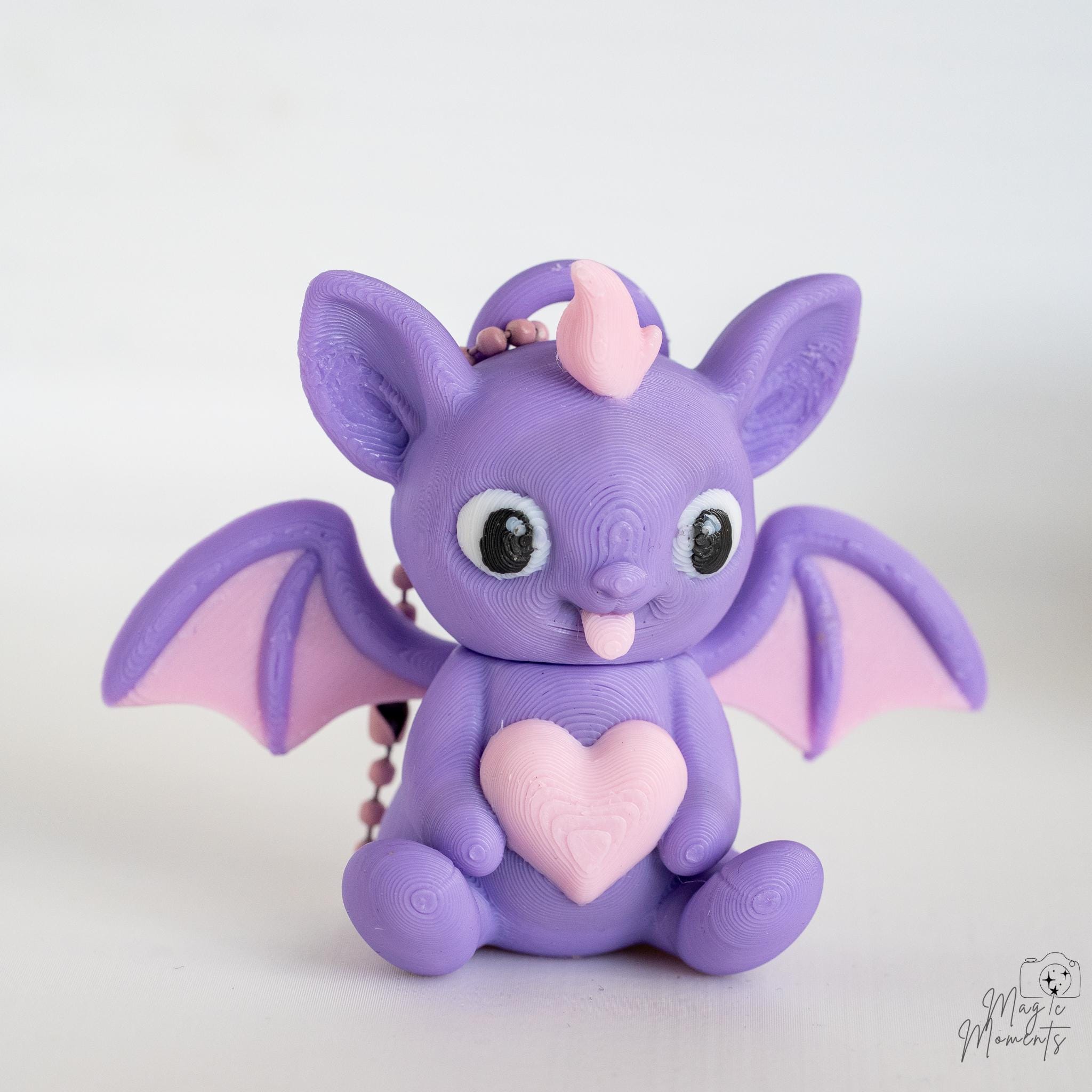 Purple bat figure with heart detail and cute wing design