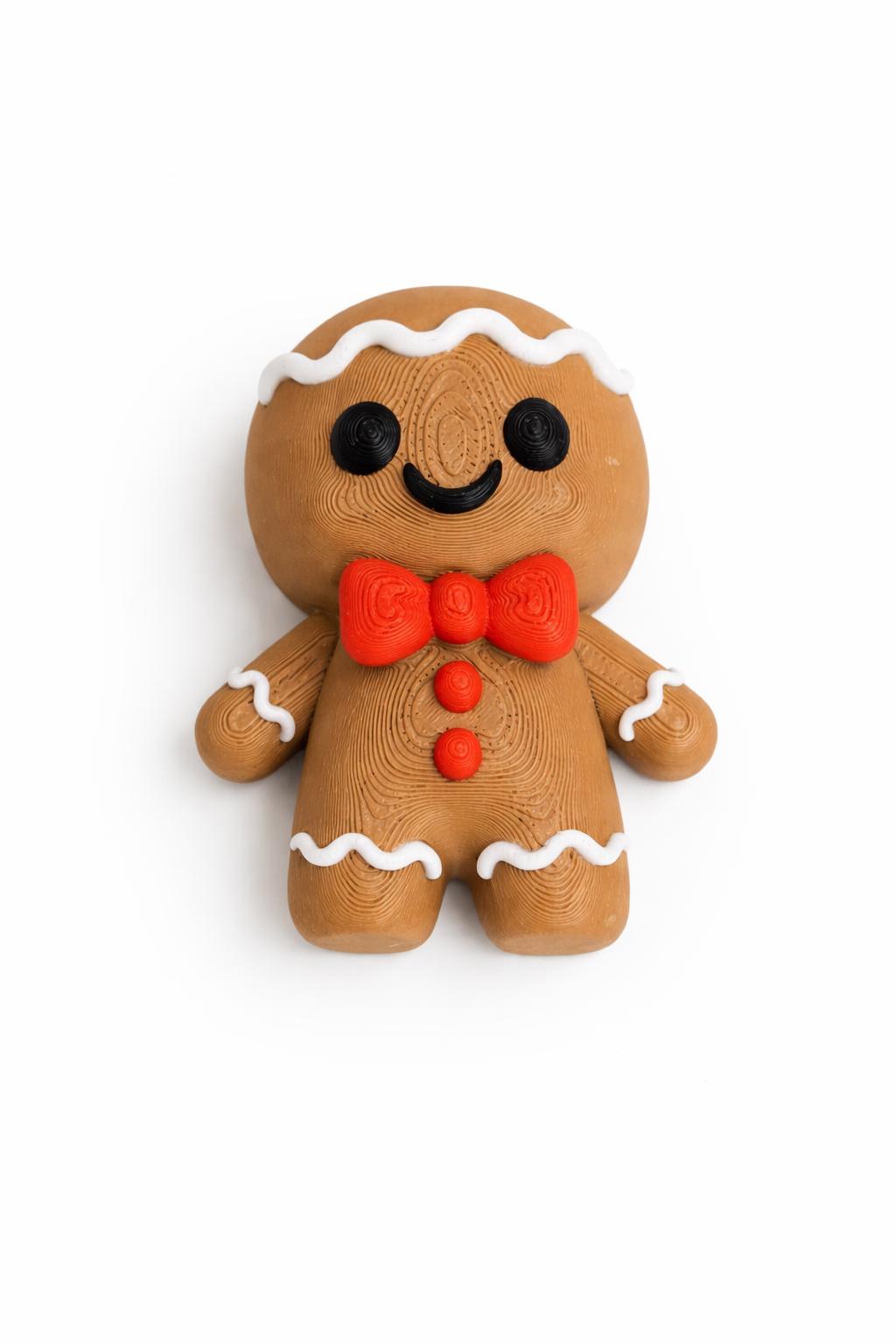 Cute gingerbread man 3D printed Christmas decoration with red bow tie