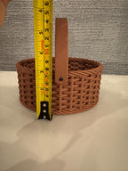 brown woven basket width next to measuring tape for scale