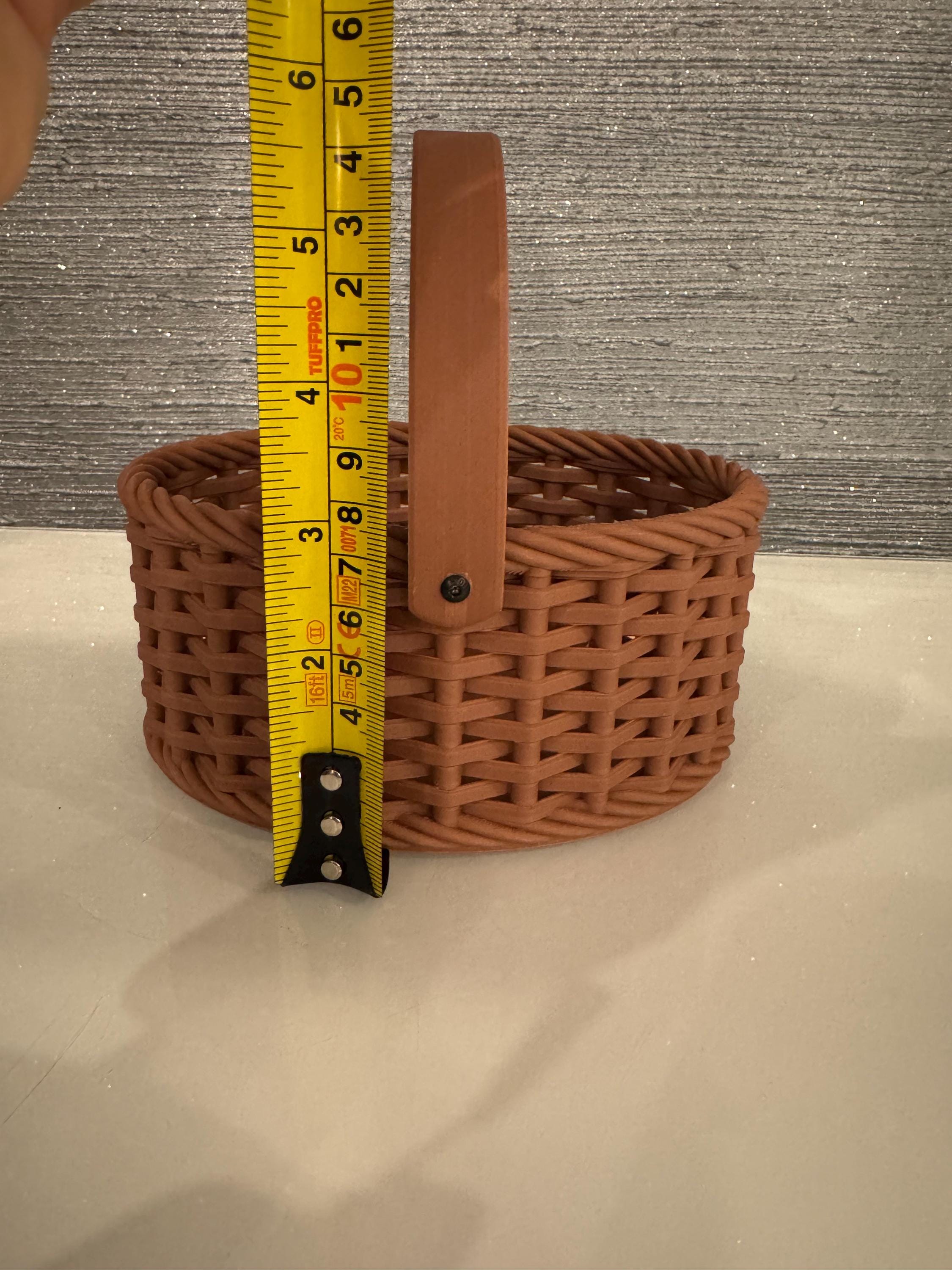 brown woven basket width next to measuring tape for scale