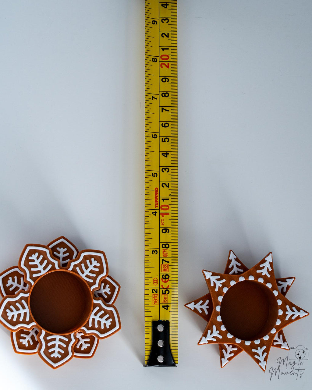 snowflake tealight holders next to measuring tape for scale