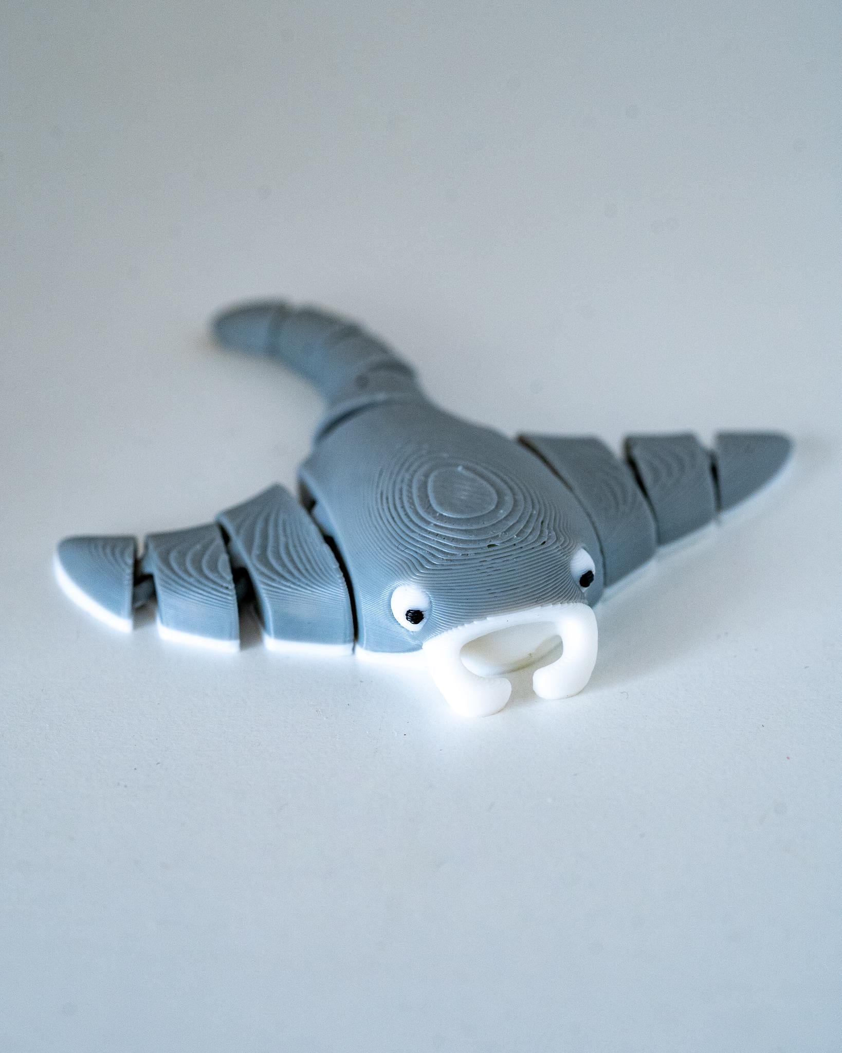 Articulated manta ray figure with flexible segmented body and fins