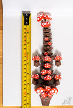 mushroom dragon next to measuring tape for scale