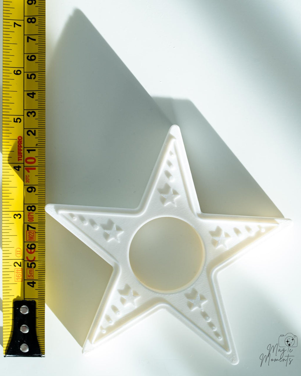 star candle holder next to measuring tape