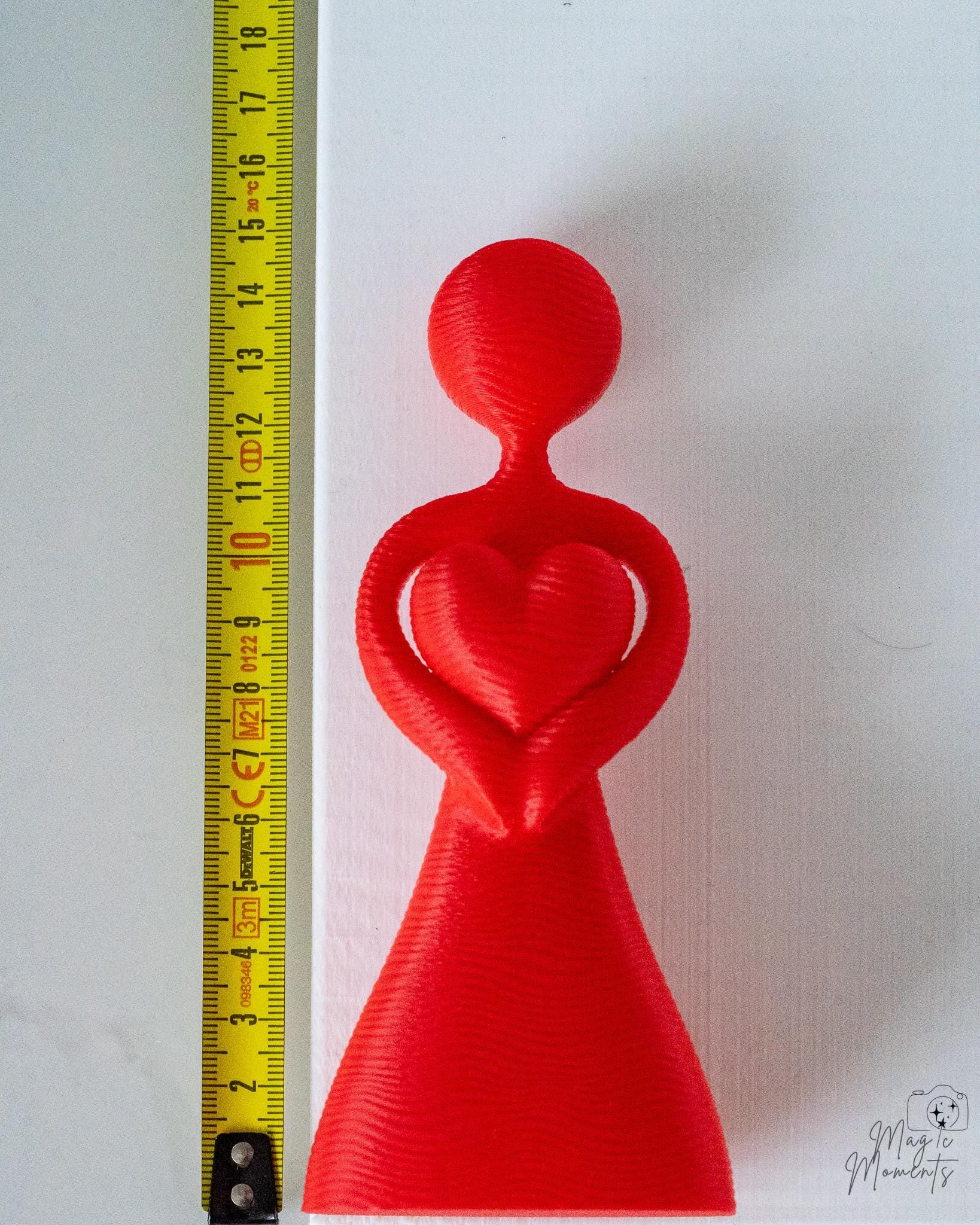Red heart couple sculpture with smooth minimalist finish
