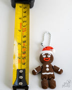 Gingerbread ornament next to measuring tape for scale