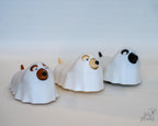 Ghost dog figures displayed in a row