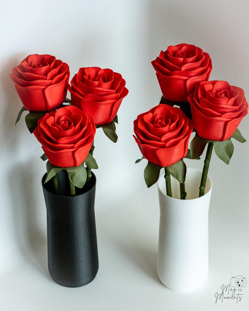 Red rose bouquet displayed in black and white vase