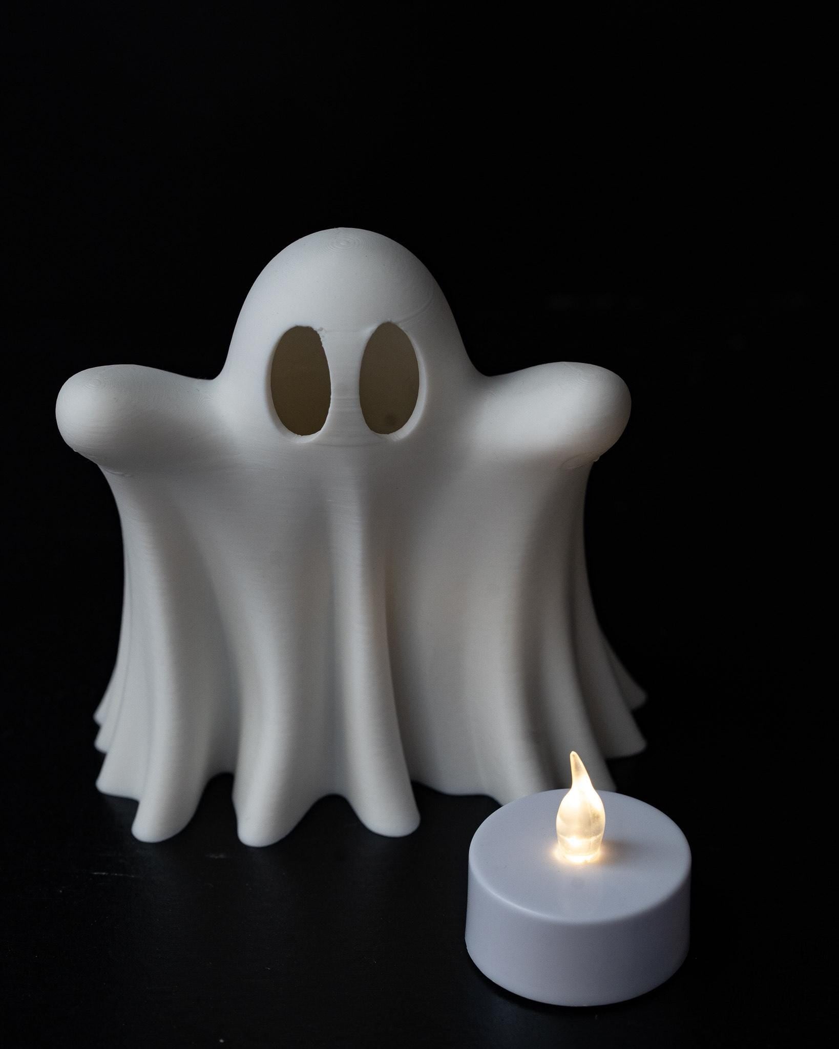 White ghost lantern with glowing eye cut outs