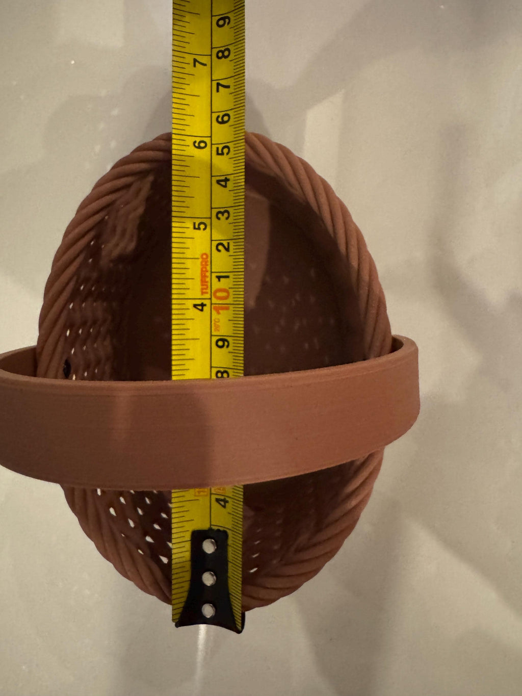 brown woven basket next to measuring tape for scale