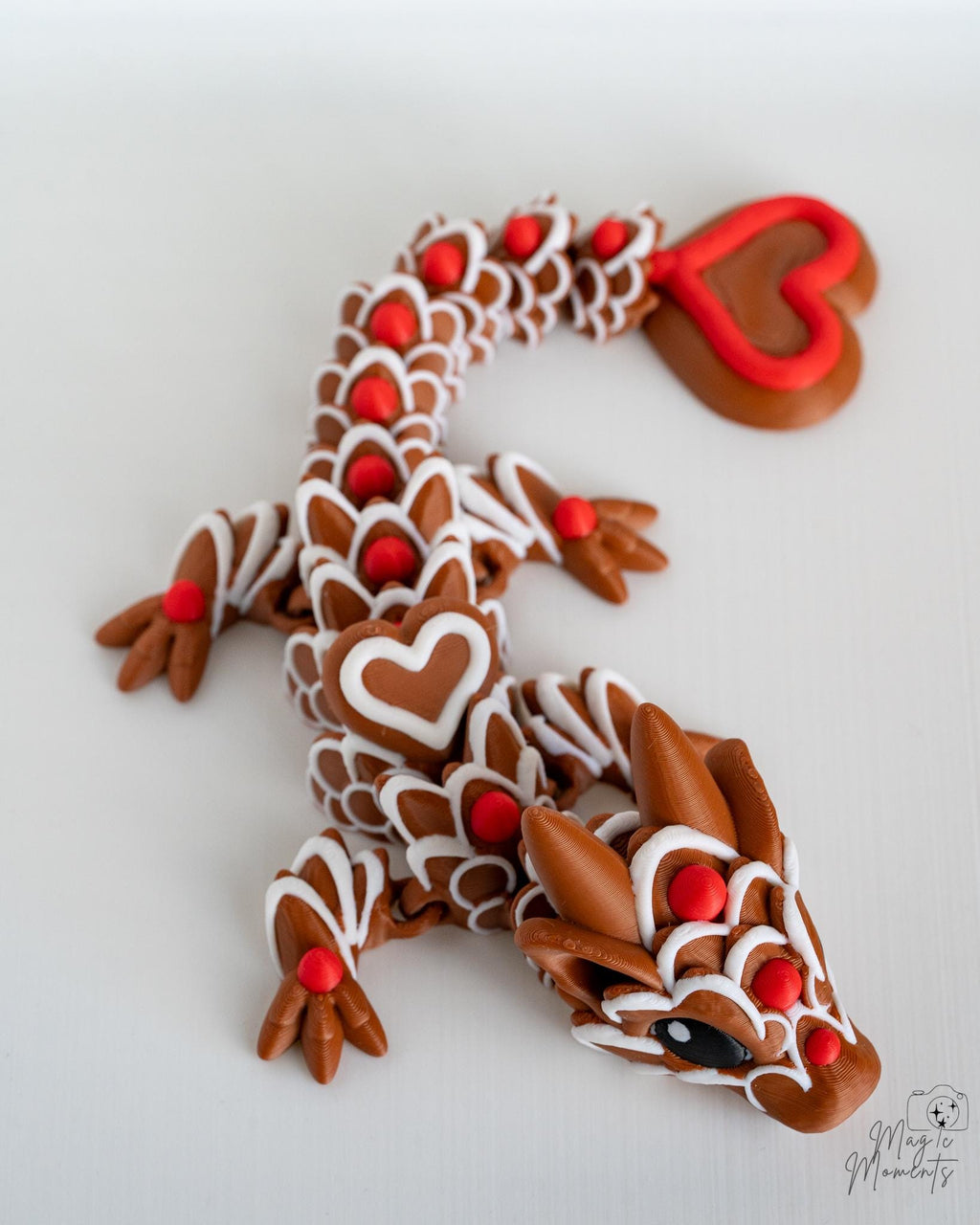 Flexible articulated dragon with red heart tail and decorative scales