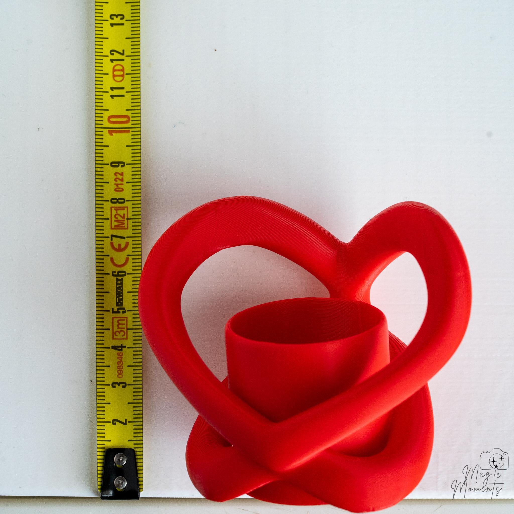 Heart shaped tealight holder next to measuring tape for scale