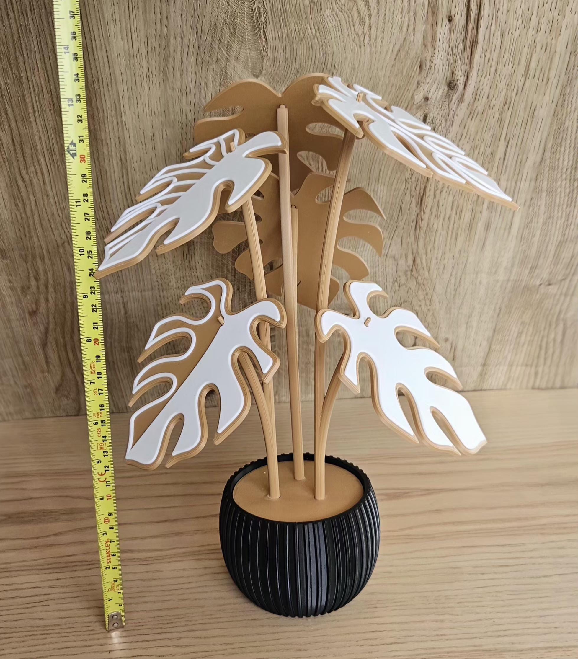 monstera decor next to measuring tape for scale