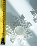 Snowflake tealight holder next to measuring tape for scale