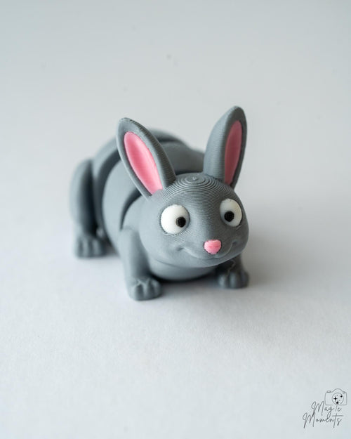 Gray rabbit-shaped toy on a white background