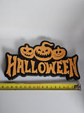 Halloween shelf decoration next to measuring tape for scale